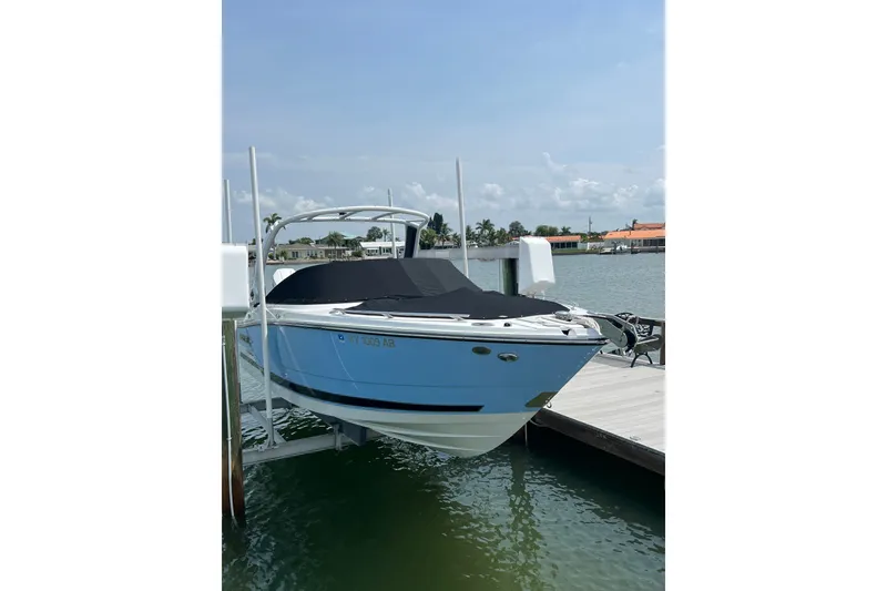 Slide: The Image of 2024 Monterey 275SS Super Sport boat docked by waterfront homes. - 8