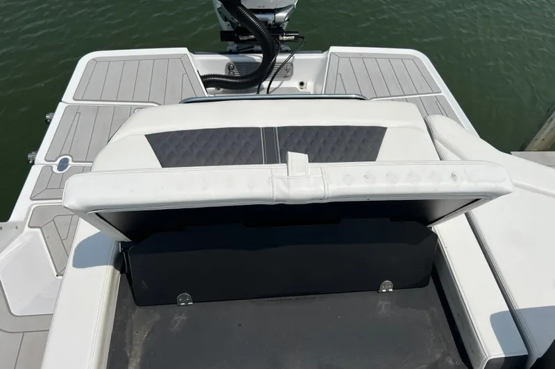 Slide: The Image of 2024 Monterey 275SS Super Sport boat interior with cushioned seating and sleek design. - 46