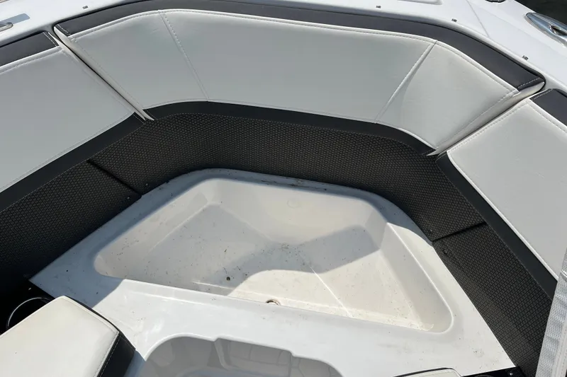 Slide: The Image of Interior seating area of 2024 Monterey 275SS Super Sport boat, featuring white and black upholstery. - 15