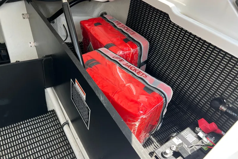 Slide: The Image of Storage compartment with life jackets in a 2024 Monterey 275SS Super Sport boat. - 50
