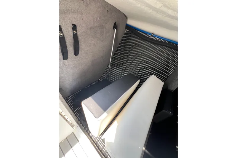 Slide: The Image of Interior storage area of 2024 Monterey 275SS Super Sport boat with cushioned seating. - 28