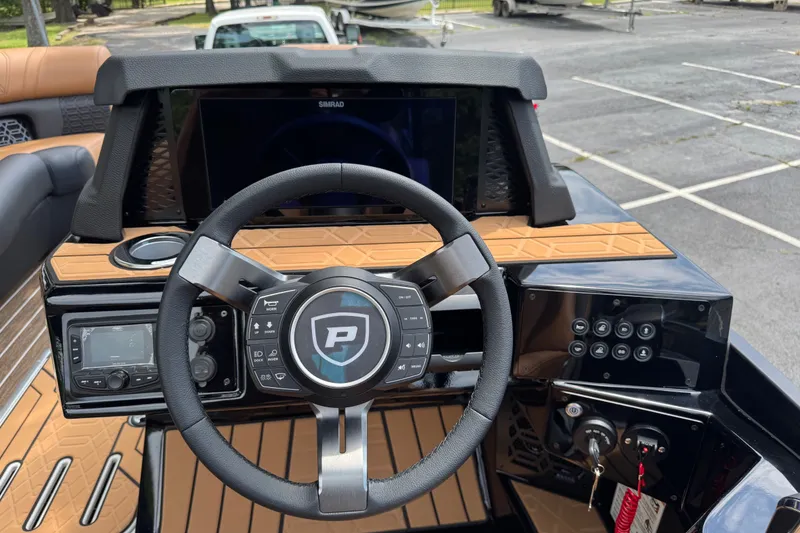 Slide: The Image of Steering console of 2027 Premier 230 Intrigue RLO - DL boat with modern controls and display. - 7
