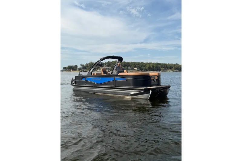 The Image of 2027 Premier 230 Intrigue RLO - DL pontoon boat on a calm lake. - 0