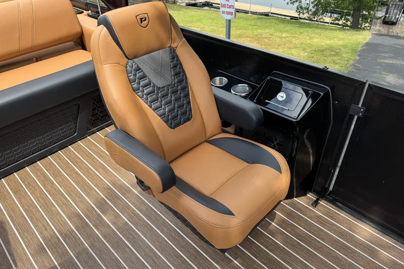 Slide: The Image of Luxurious seating on 2027 Premier 230 Intrigue RLO - DL boat, featuring tan and black upholstery. - 8