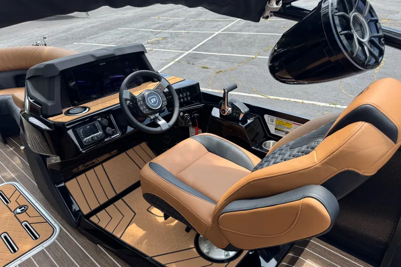 Slide: The Image of Luxurious 2027 Premier 230 Intrigue RLO - DL boat interior with modern steering and seating. - 6