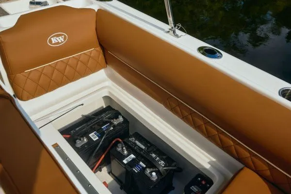 Slide: The Image of 2027 Key West 239 DFS boat interior with brown seating and visible battery compartment. - 23