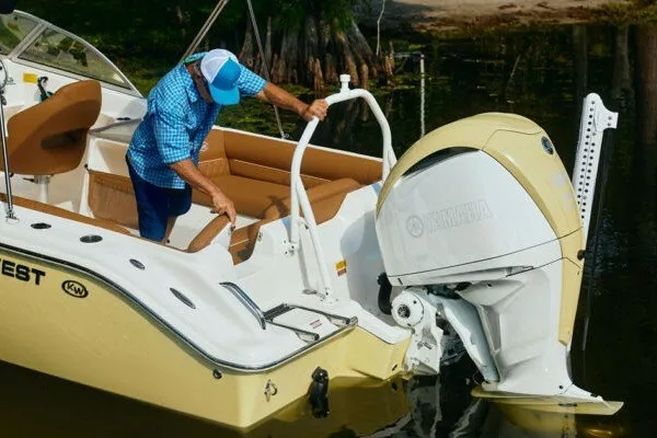 Slide: The Image of Man on Key West 239 DFS boat, 2027 model, adjusting Yamaha outboard motor. - 25