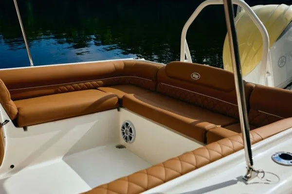 Slide: The Image of 2027 Key West 239 DFS boat interior with brown cushioned seating and speaker. - 20