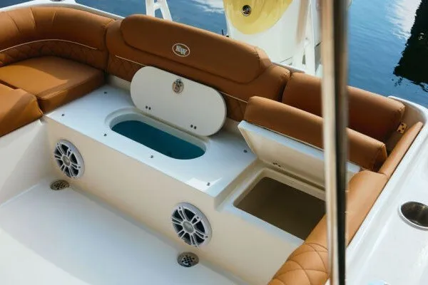 Slide: The Image of 2027 Key West 239 DFS boat interior with tan seating and storage compartments. - 21