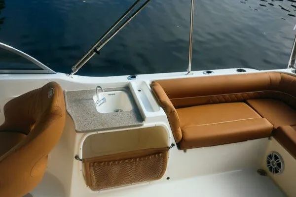 Slide: The Image of 2027 Key West 239 DFS boat interior with tan seating and built-in sink. - 17
