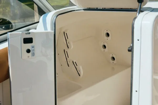 Slide: The Image of Interior view of a 2027 Key West 239 DFS boat compartment with storage features. - 14