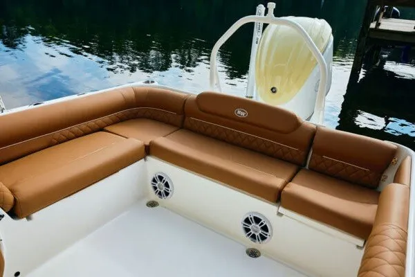 Slide: The Image of Luxurious seating on 2027 Key West 239 DFS boat with brown cushions and water backdrop. - 19