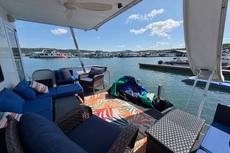 Slide: The Image of Houseboat deck with cozy seating, colorful rug, and scenic marina view. Funtime 16x70, 2008 model. - 48