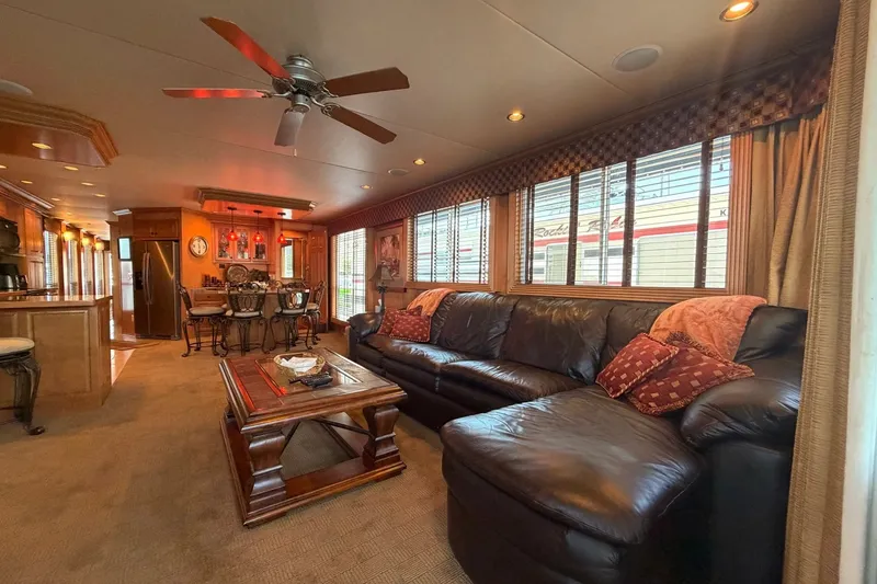 Slide: The Image of Luxurious 2008 Funtime 16x70 houseboat interior with leather sofa, dining area, and modern kitchen. - 18