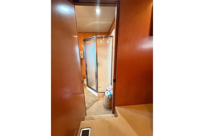 Slide: The Image of Interior of 2008 Funtime 16x70 showing bathroom with shower and wooden accents. - 34