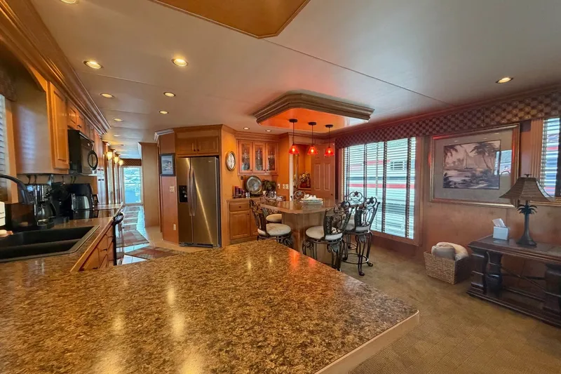 Slide: The Image of Luxurious kitchen interior of 2008 Funtime 16x70 houseboat with modern amenities and elegant decor. - 22