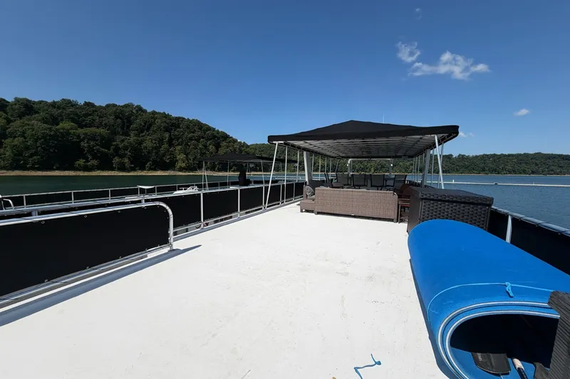 Slide: The Image of 2008 Funtime 16x70 houseboat with canopy, outdoor seating, and scenic lake view. - 10