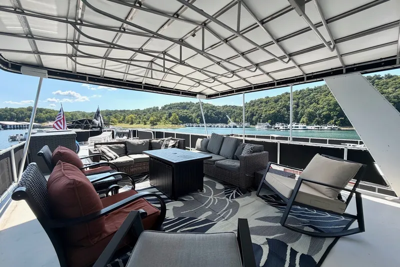 Slide: The Image of Luxurious 2008 Funtime 16x70 houseboat deck with comfortable seating and scenic lake view. - 7