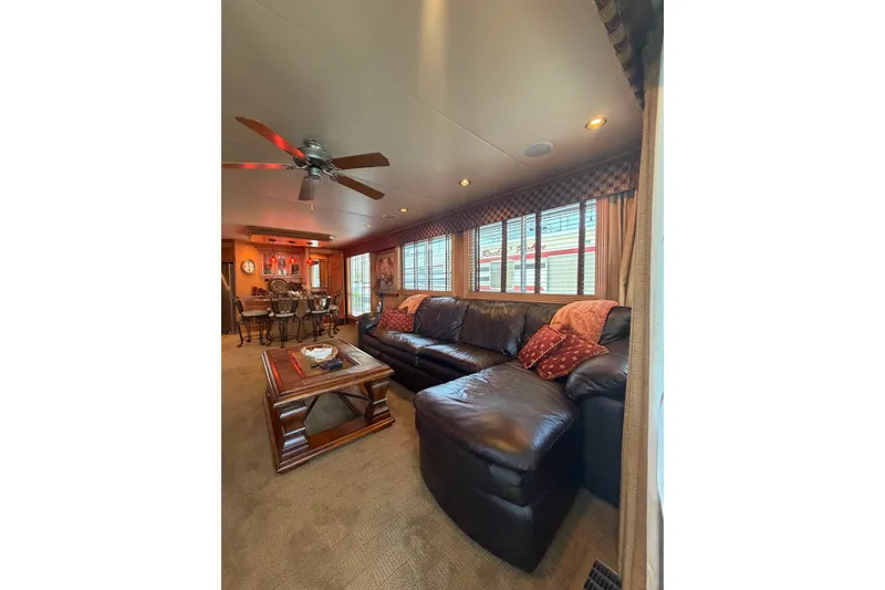 Slide: The Image of Luxurious 2008 Funtime 16x70 houseboat interior with leather sofa and elegant decor. - 16