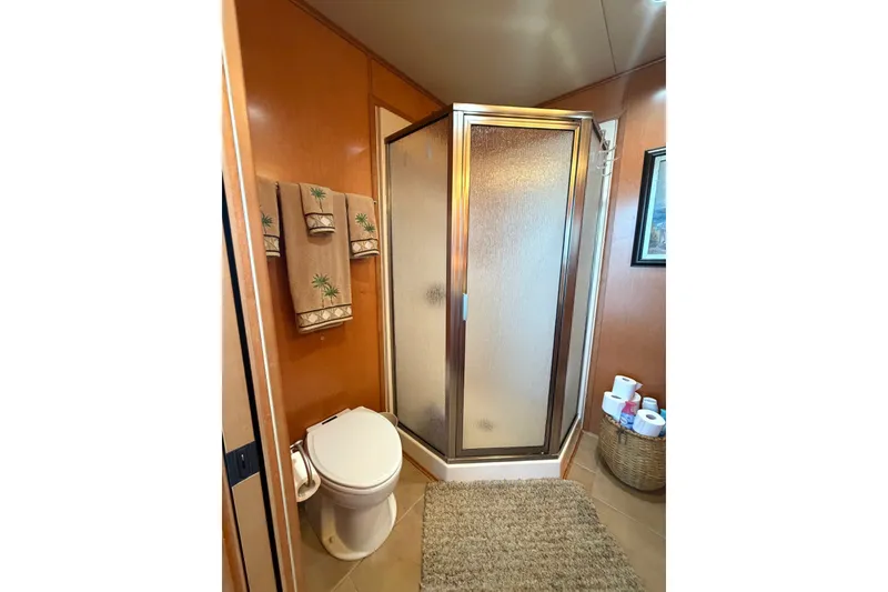 Slide: The Image of Bathroom in 2008 Funtime 16x70 houseboat with shower, toilet, and decorative towels. - 35
