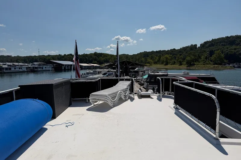 Slide: The Image of Top deck of 2008 Funtime 16x70 houseboat with loungers and scenic lake view. - 11
