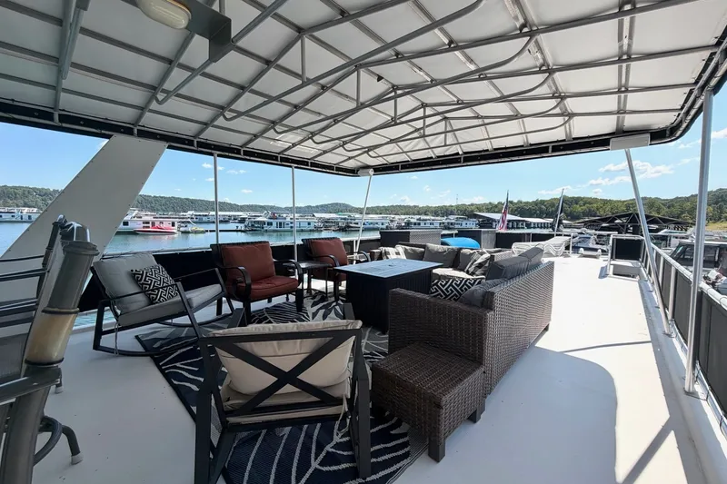 Slide: The Image of Spacious deck of 2008 Funtime 16x70 houseboat with comfortable seating and scenic marina view. - 6