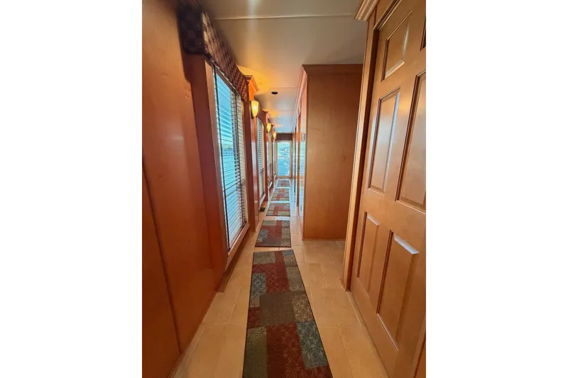 Slide: The Image of Hallway inside 2008 Funtime 16x70 houseboat with wooden paneling and carpeted floor. - 31