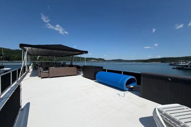 Slide: The Image of Spacious deck of 2008 Funtime 16x70 houseboat with seating and scenic lake view. - 9