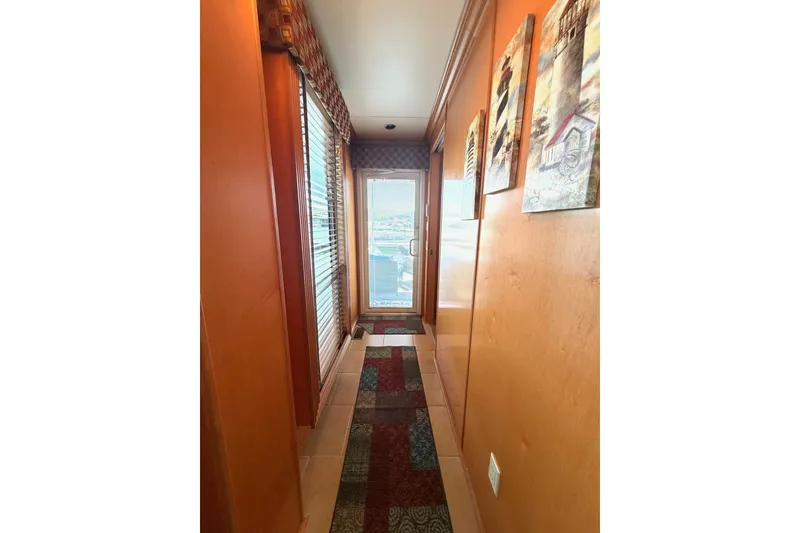 Slide: The Image of Narrow hallway in 2008 Funtime 16x70 model with colorful rug and wall art. - 41