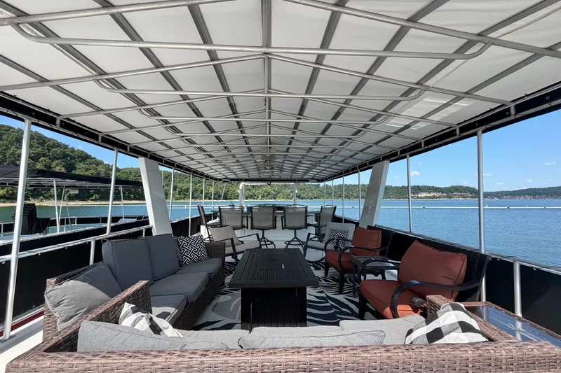 Slide: The Image of Spacious deck of 2008 Funtime 16x70 houseboat with comfortable seating and scenic lake view. - 8