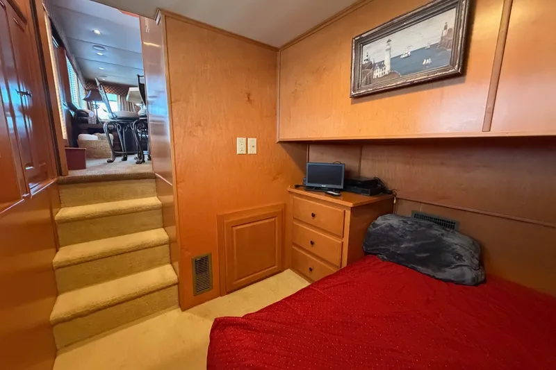Slide: The Image of Cozy cabin interior of 2008 Funtime 16x70 houseboat with bed, stairs, and decor. - 28