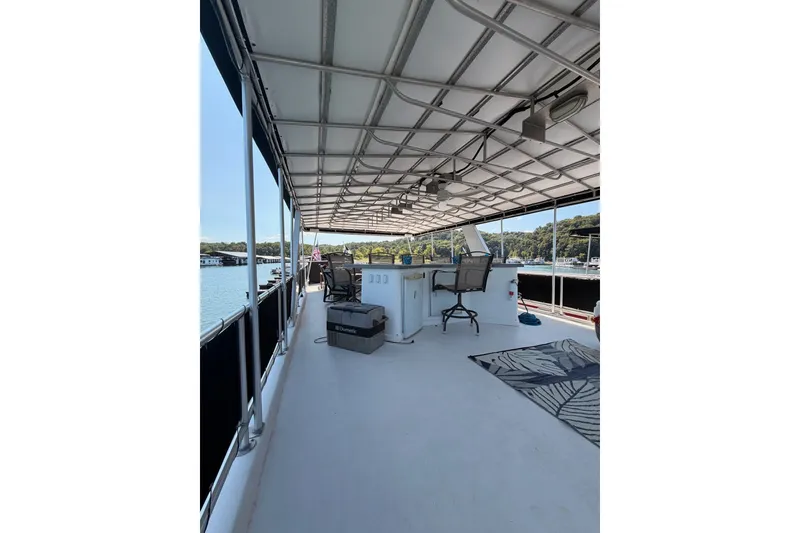 Slide: The Image of Spacious deck of 2008 Funtime 16x70 houseboat with seating and scenic lake view. - 2