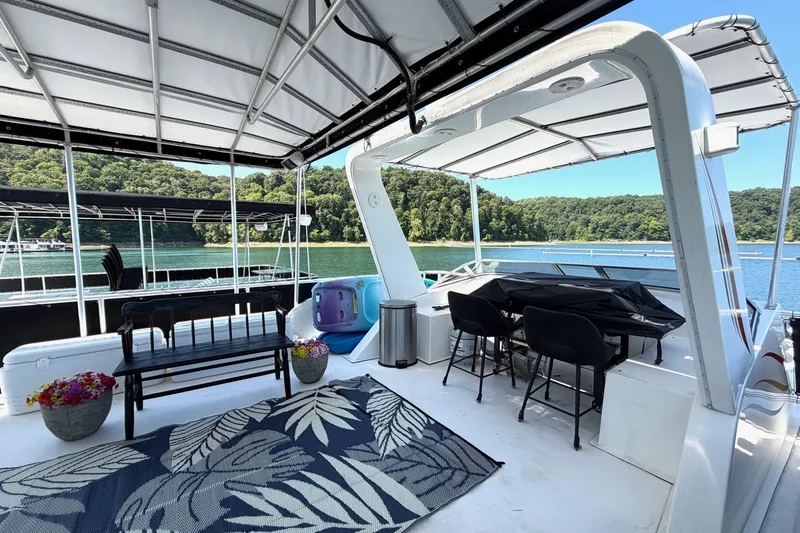 Slide: The Image of Upper deck of 2008 Funtime 16x70 houseboat with seating, table, and scenic lake view. - 4