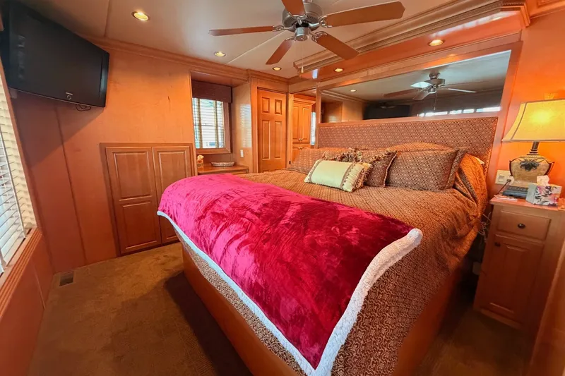 Slide: The Image of Luxurious bedroom in 2008 Funtime 16x70 houseboat with plush bedding and warm lighting. - 42