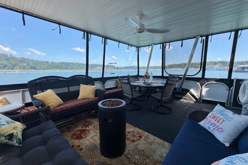Slide: The Image of Spacious 2008 Funtime 16x70 houseboat interior with cozy seating and scenic lake views. - 12
