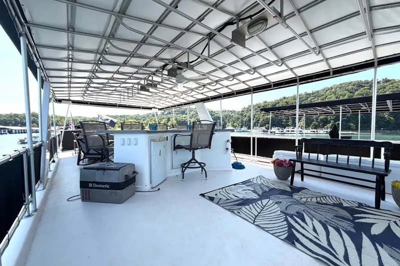 Slide: The Image of Spacious deck of 2008 Funtime 16x70 houseboat with seating and scenic lake view. - 3