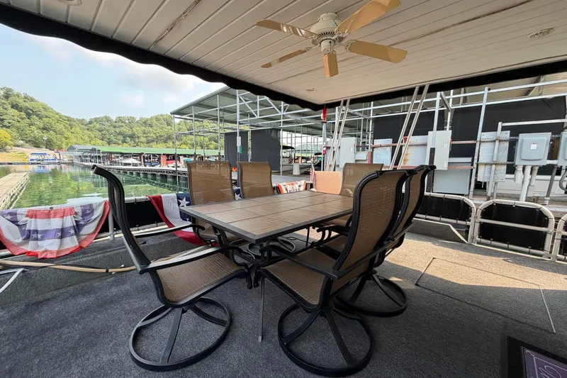 Slide: The Image of Outdoor dining area on a Lakeview houseboat with lake and dock views. - 2