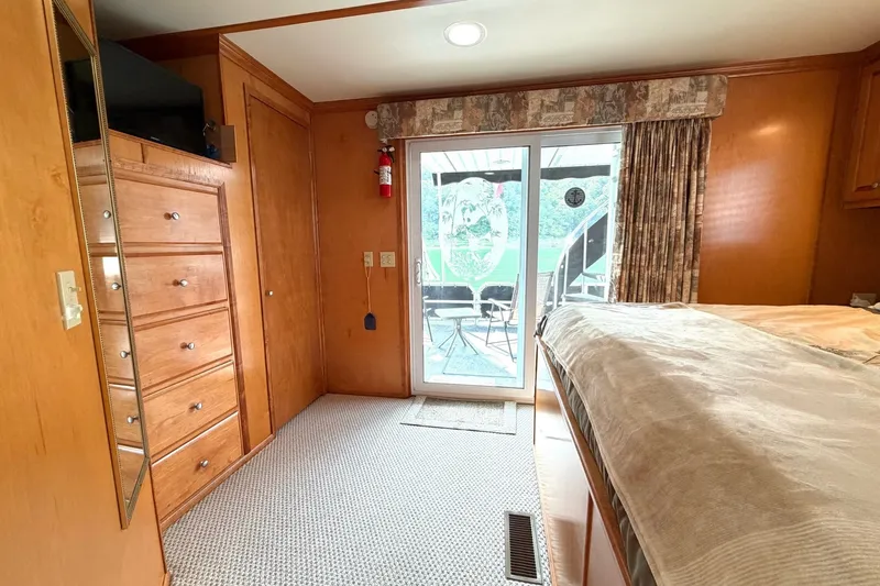 Slide: The Image of Cozy Lakeview interior with wooden cabinetry, sliding glass door, and outdoor view. - 32