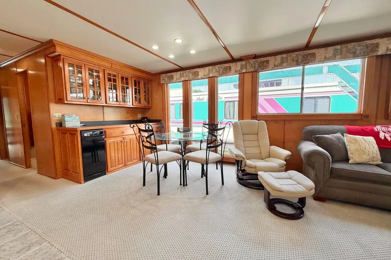 Slide: The Image of Spacious Lakeview houseboat interior with wooden cabinetry, dining area, and comfortable seating. - 16