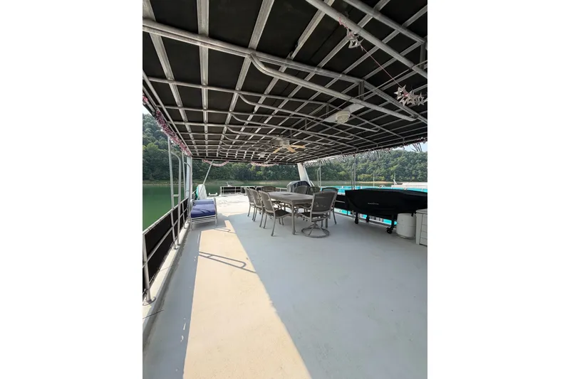 Slide: The Image of Spacious Lakeview boat deck with seating, covered roof, and scenic water view. - 41