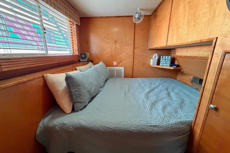 Slide: The Image of Cozy Lakeview cabin bedroom with wooden walls, bed, and decorative sign. - 25