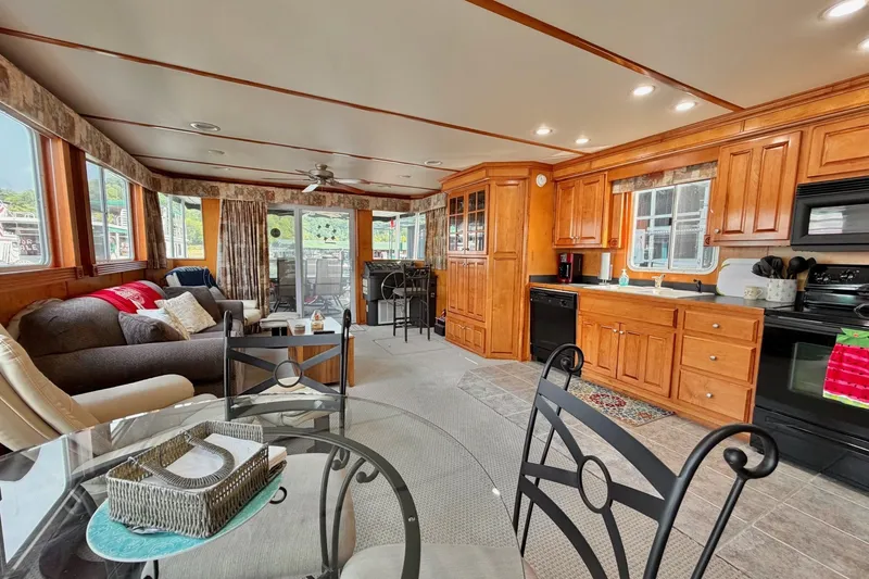 Slide: The Image of Spacious Lakeview houseboat interior with cozy living area, kitchen, and dining space. - 18