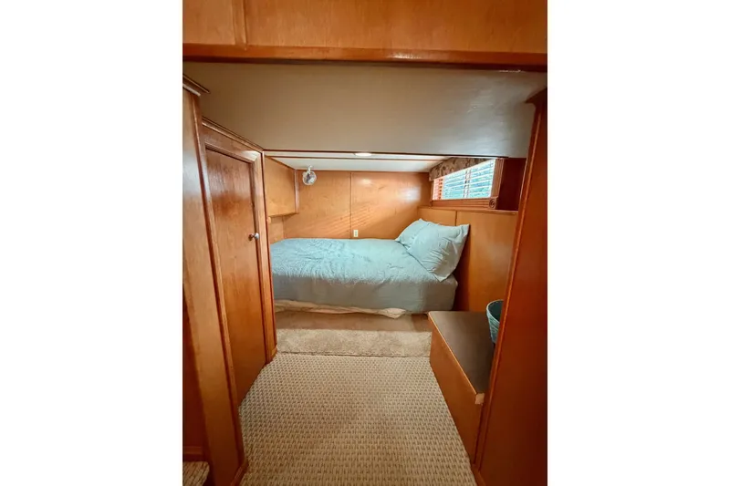 Slide: The Image of Cozy Lakeview cabin bedroom with wooden walls, blue bedding, and natural light. - 28