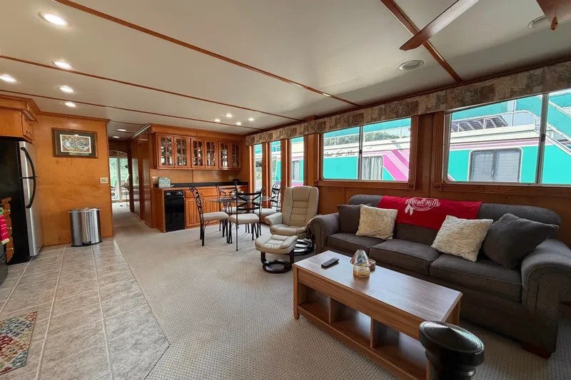 Slide: The Image of Spacious Lakeview houseboat interior with cozy seating, dining area, and large windows. - 12