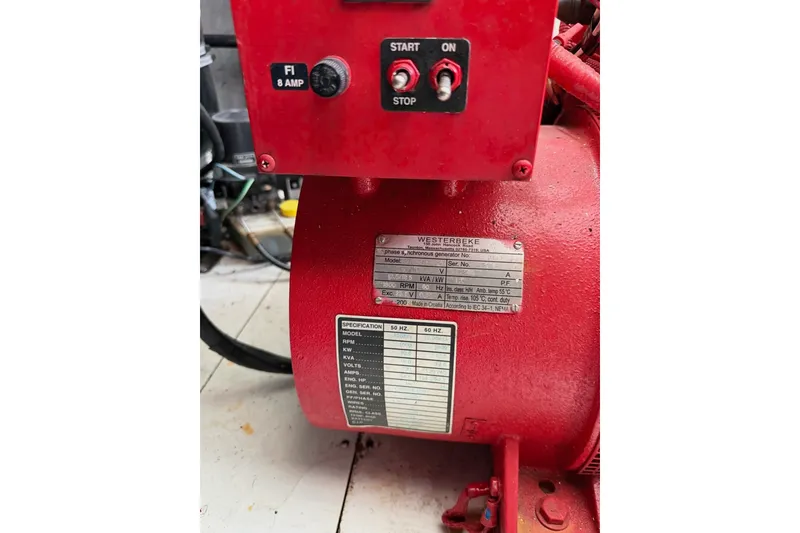 Slide: The Image of Red Westerbeke generator with control panel and specification plate, featuring start and stop buttons. - 55