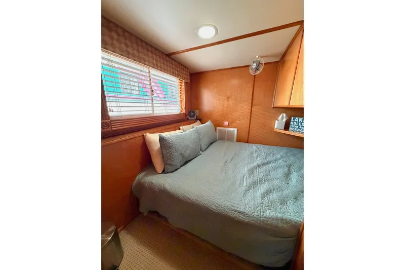 Slide: The Image of Cozy Lakeview bedroom with wooden walls, large bed, and window blinds. - 26