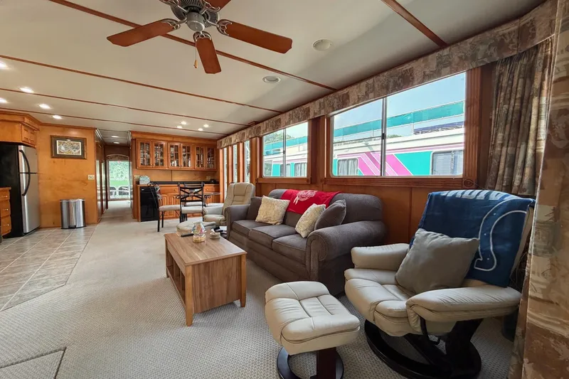 Slide: The Image of Luxurious Lakeview houseboat interior with cozy seating, large windows, and modern kitchen. - 6