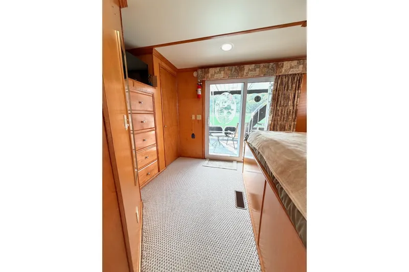 Slide: The Image of Cozy Lakeview interior with wooden cabinets, carpeted floor, and sliding glass door. - 33