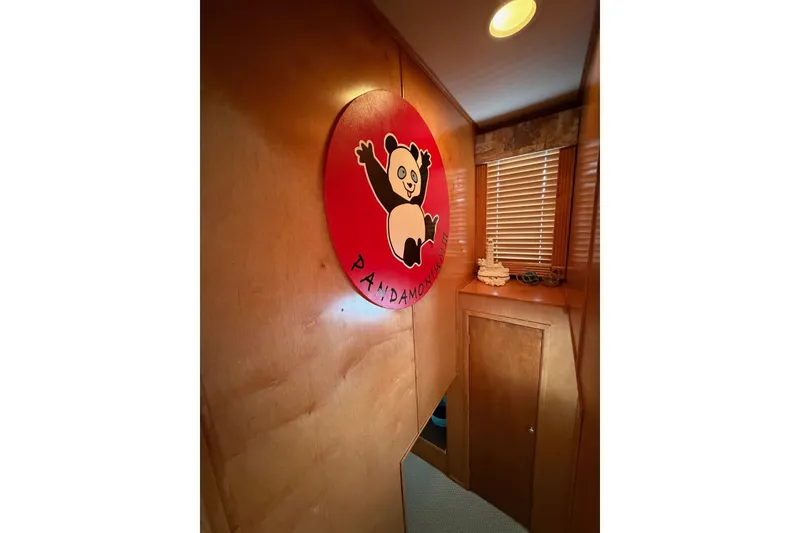 Slide: The Image of Wood-paneled hallway with panda-themed decor and small cabinet, featuring Lakeview design. - 24