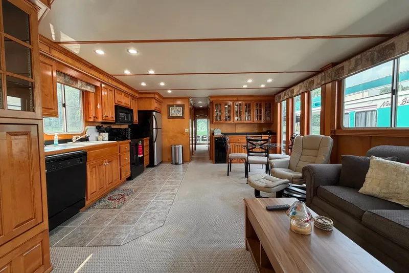 Slide: The Image of Spacious Lakeview houseboat interior with wooden cabinetry, modern kitchen, and cozy living area. - 14